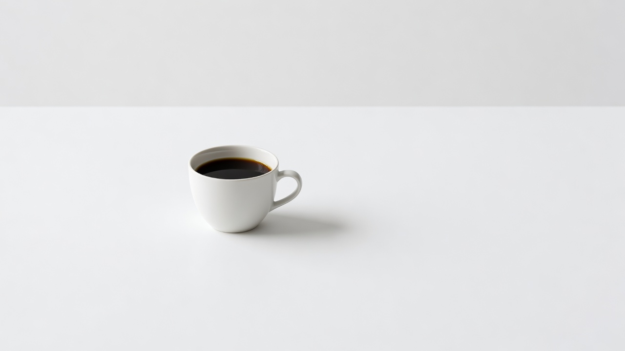 Minimalistische foto: witte kop koffie op wit vlak